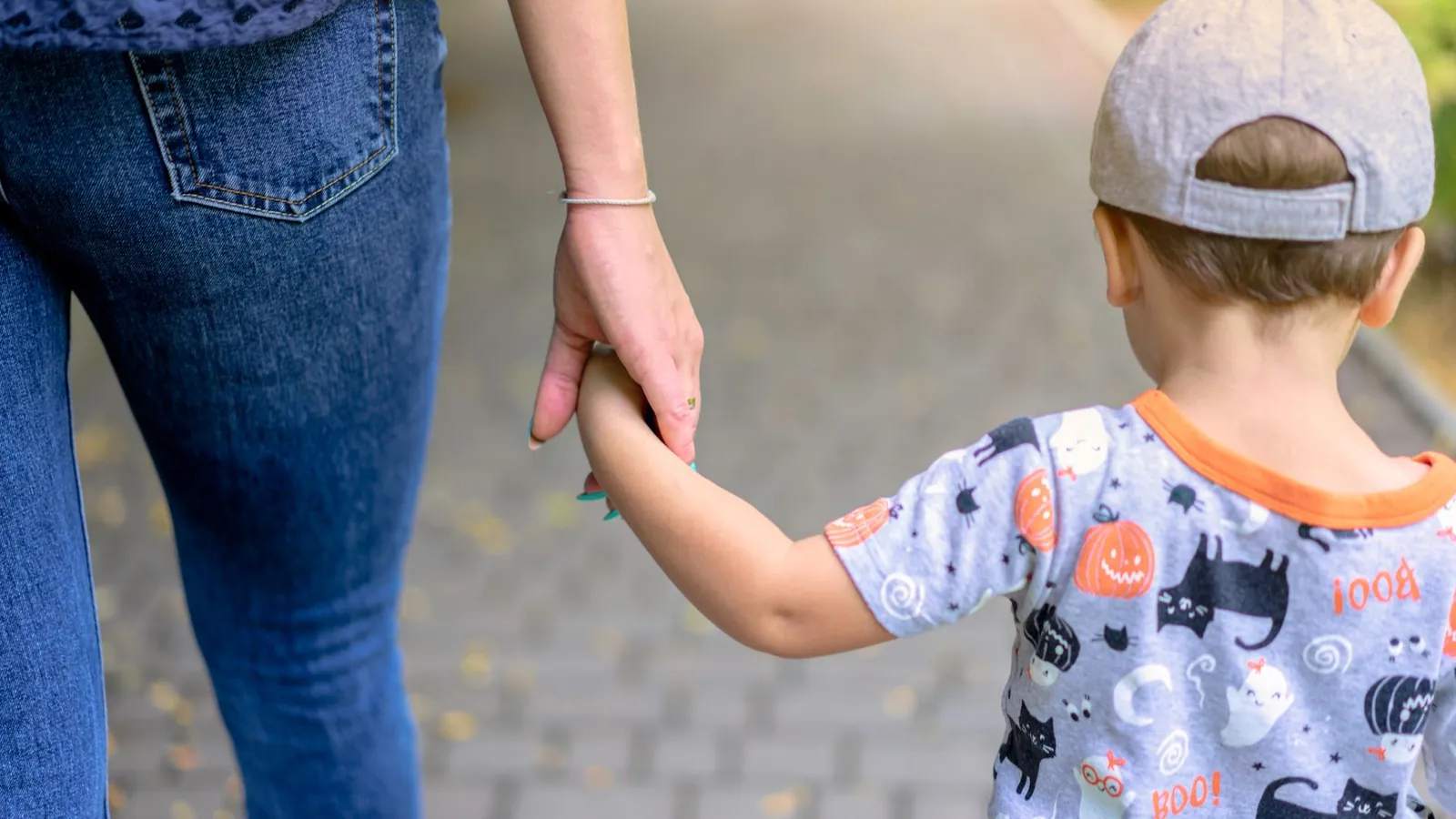 A parent and child walking together