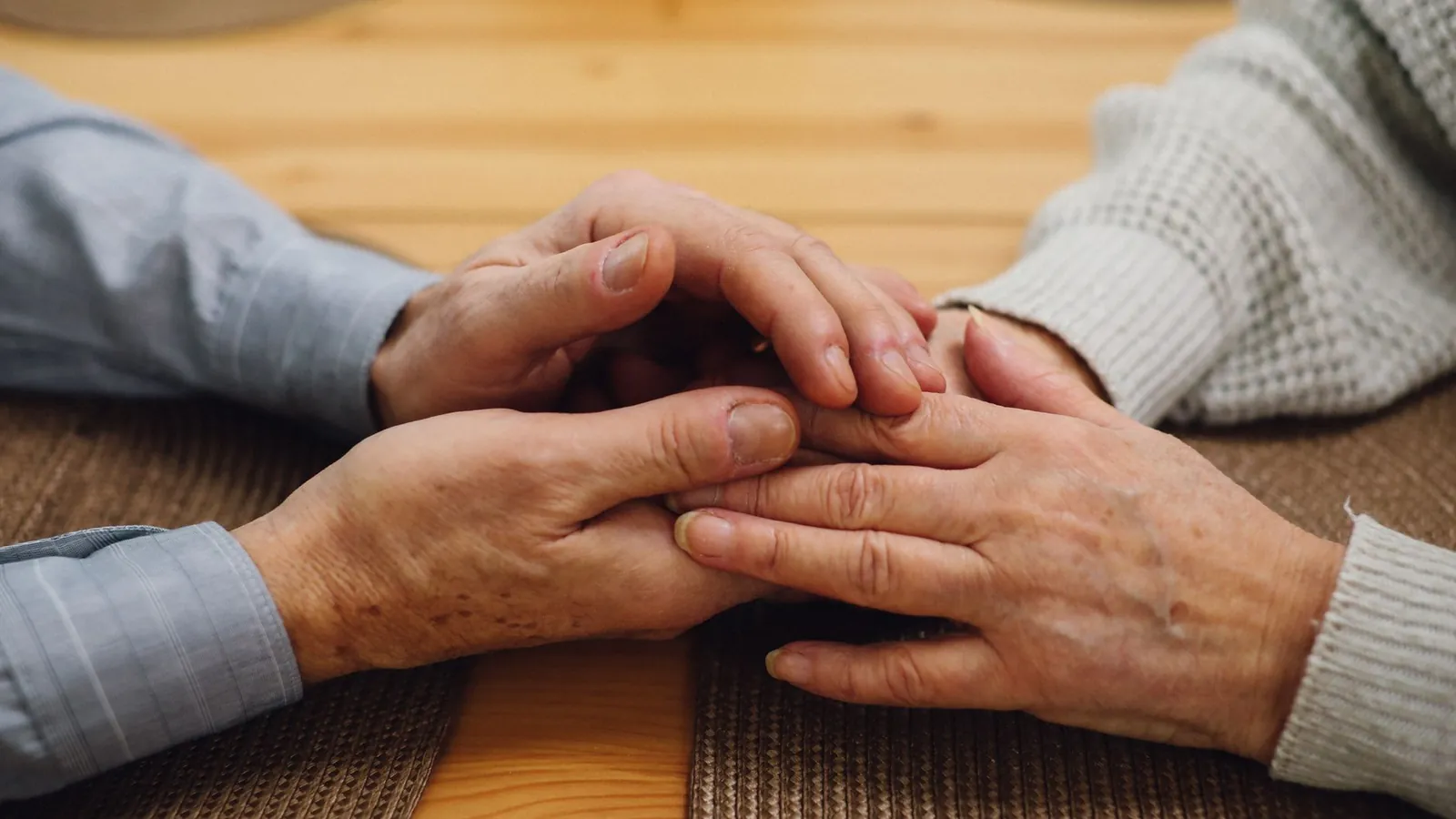 A younger hand holding an older hand